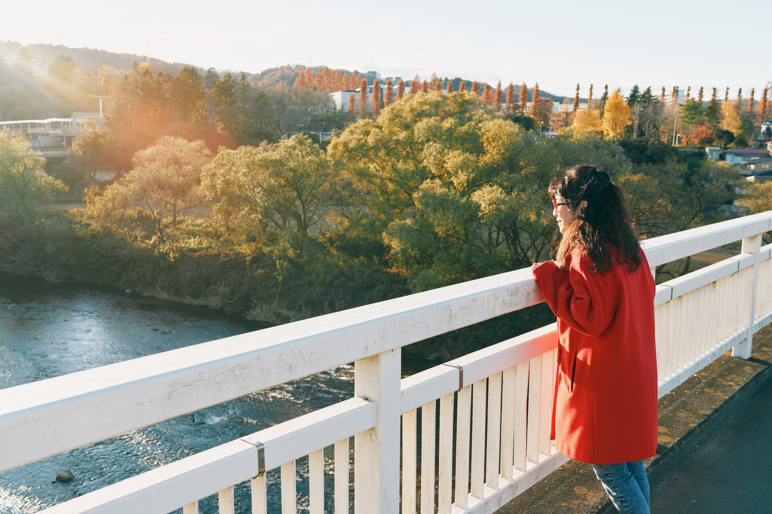 高校時代に幾度も渡った仲の瀬橋にて。広瀬川の流れや川辺の紅葉を眺めながら、「なんて美しいんでしょう！」と高橋さん。こうして豊かな自然がそばにあることも、仙台で暮らす喜びだという。